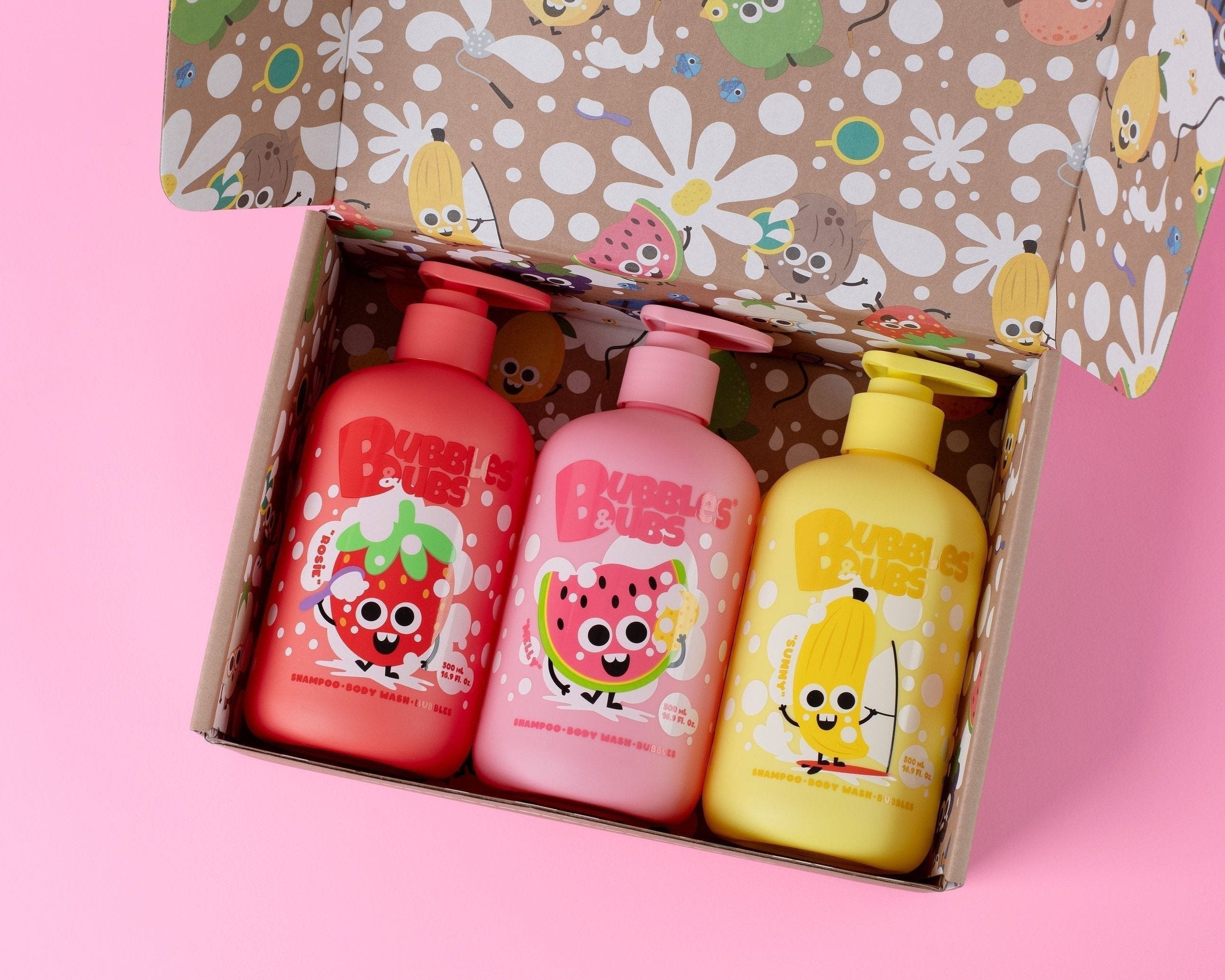 Three bubbles and bubs products in a gift box, inside the box you find Rosie the strawberry, Melly the water Mellon and Sunny the banana shampoo bottles from bubbles and bubs