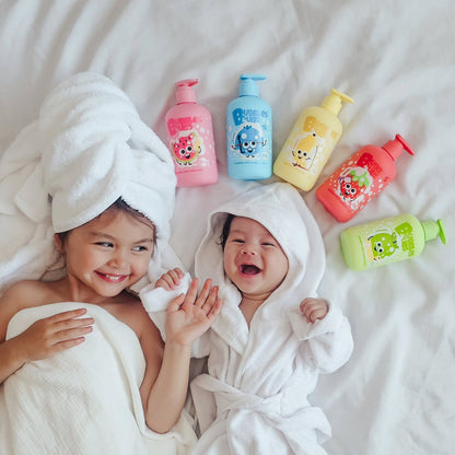 two little girls lying on the bed after bath wearing bath ropes and the five fruity friends bottles form bubbles and bubs above them on the bed